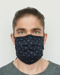 Alec is wearing an indigo foulard pattern mask
