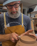 Peter Scheer (Omaha, NE) wearing copper pottery apron. 
