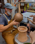 Peter Scheer (Omaha, NE) wearing copper pottery apron. 