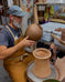 Peter Scheer (Omaha, NE) wearing copper pottery apron. 